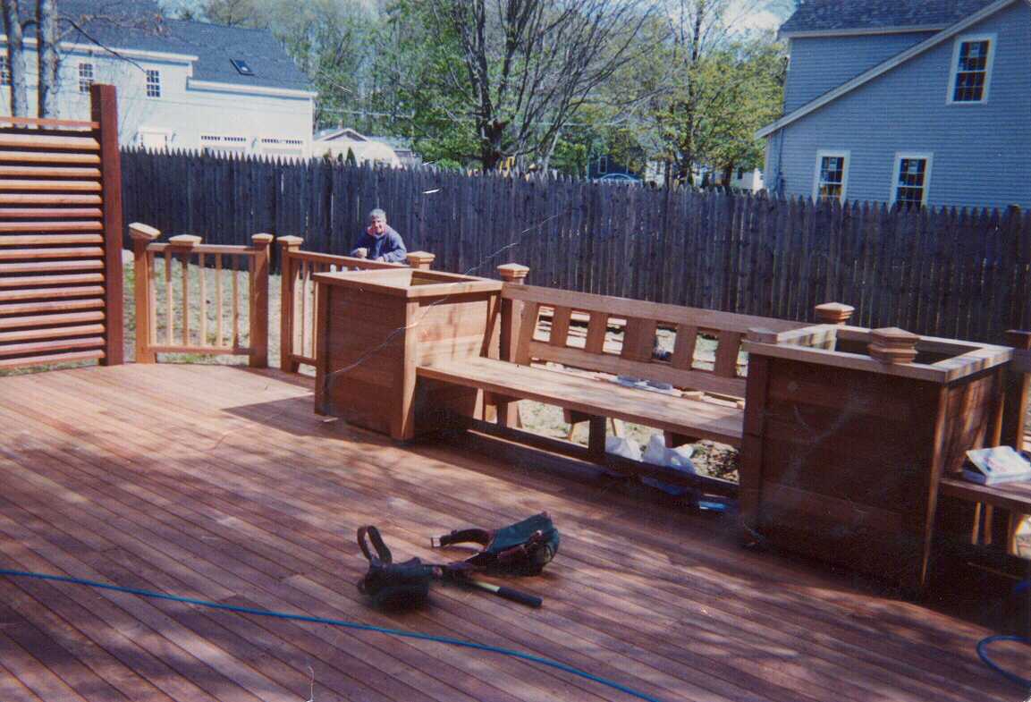 Mahogany deck, screen, benchwork and planters.  Stairs to grade.  Step work in rear.