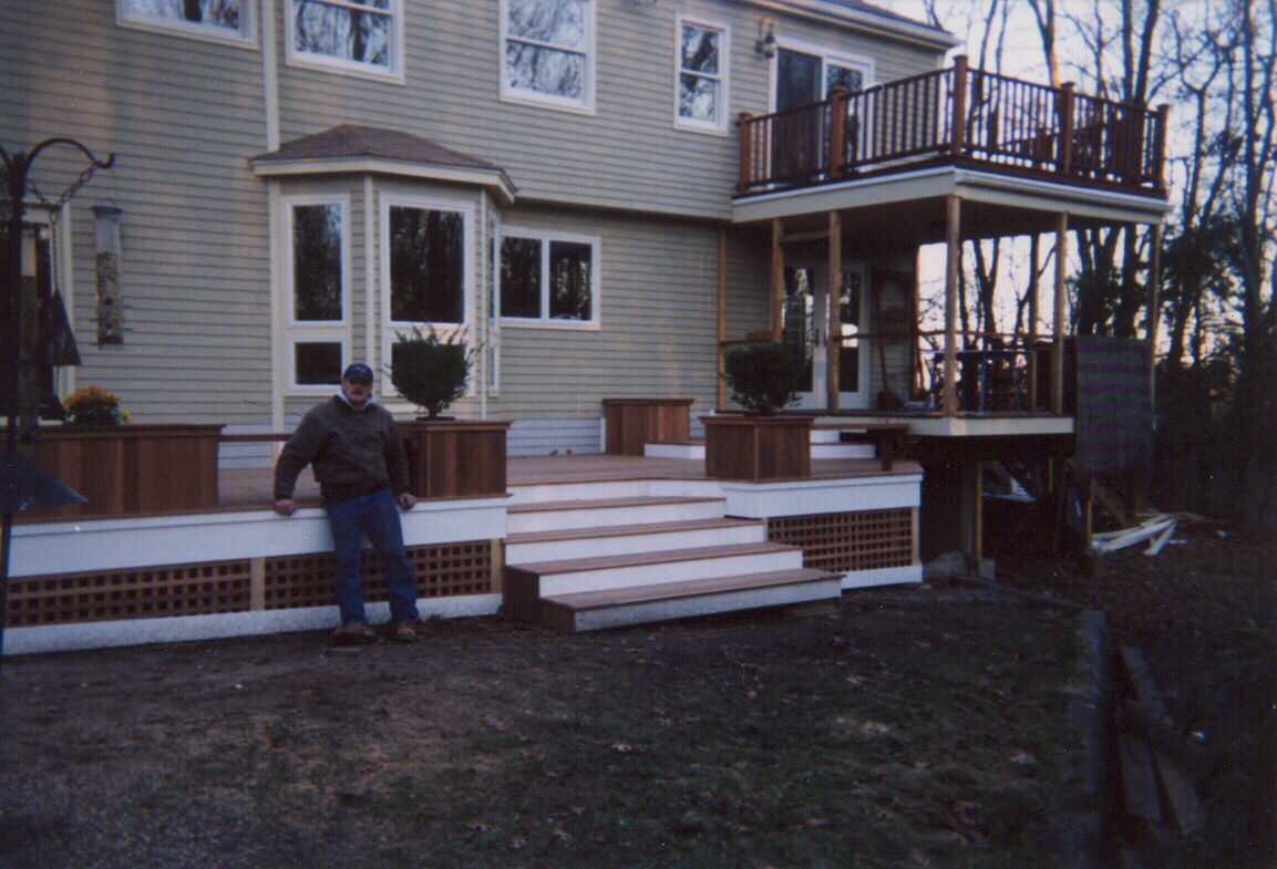 Low level deck with creened room and walk out deck above.  Bench work with planters.