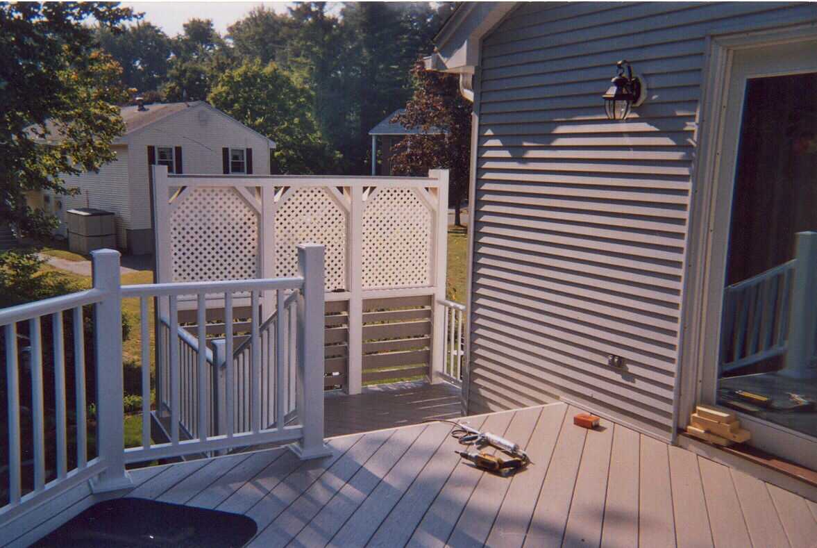 Tall composite deck with privacy screen and stairs.  Also front entry door.