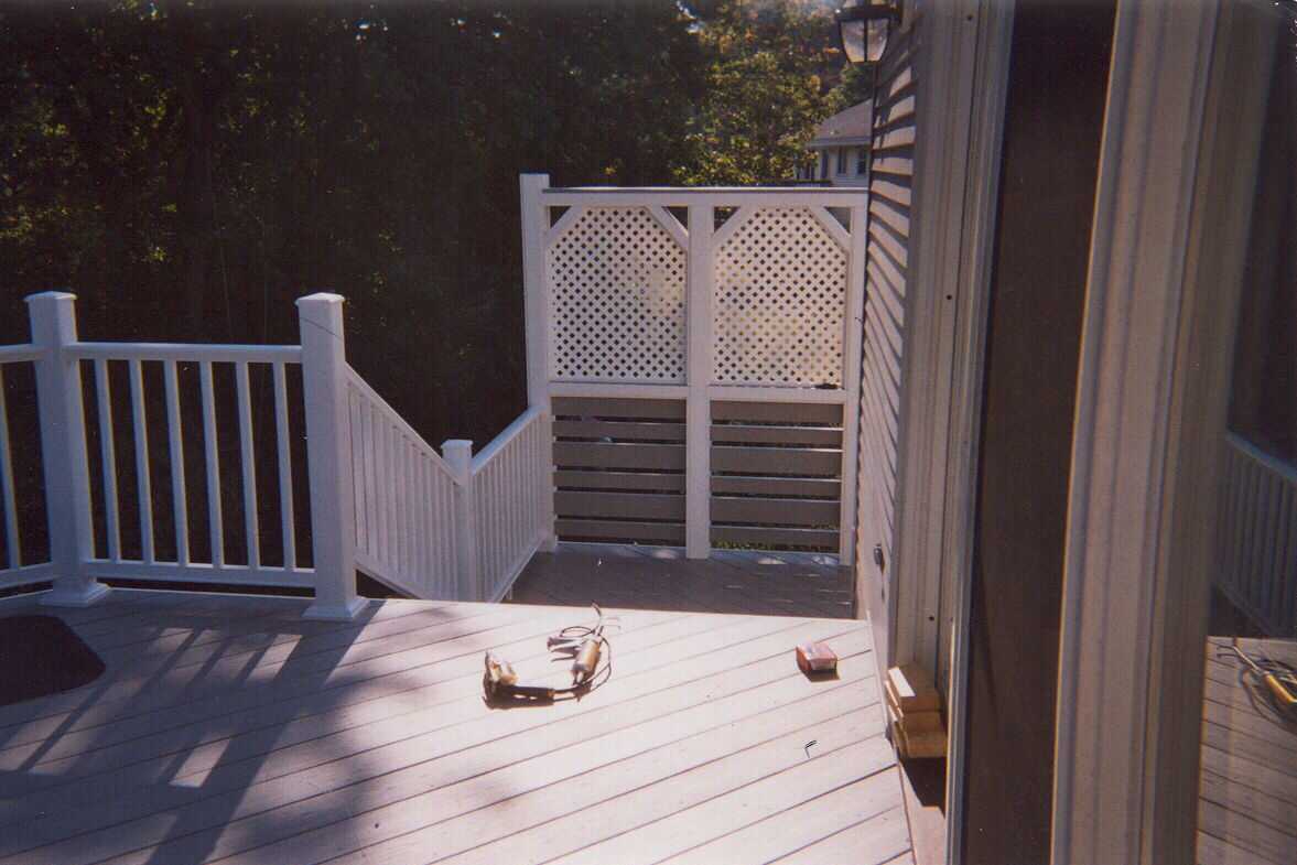 Tall composite deck with privacy screen and stairs.  Also front entry door.