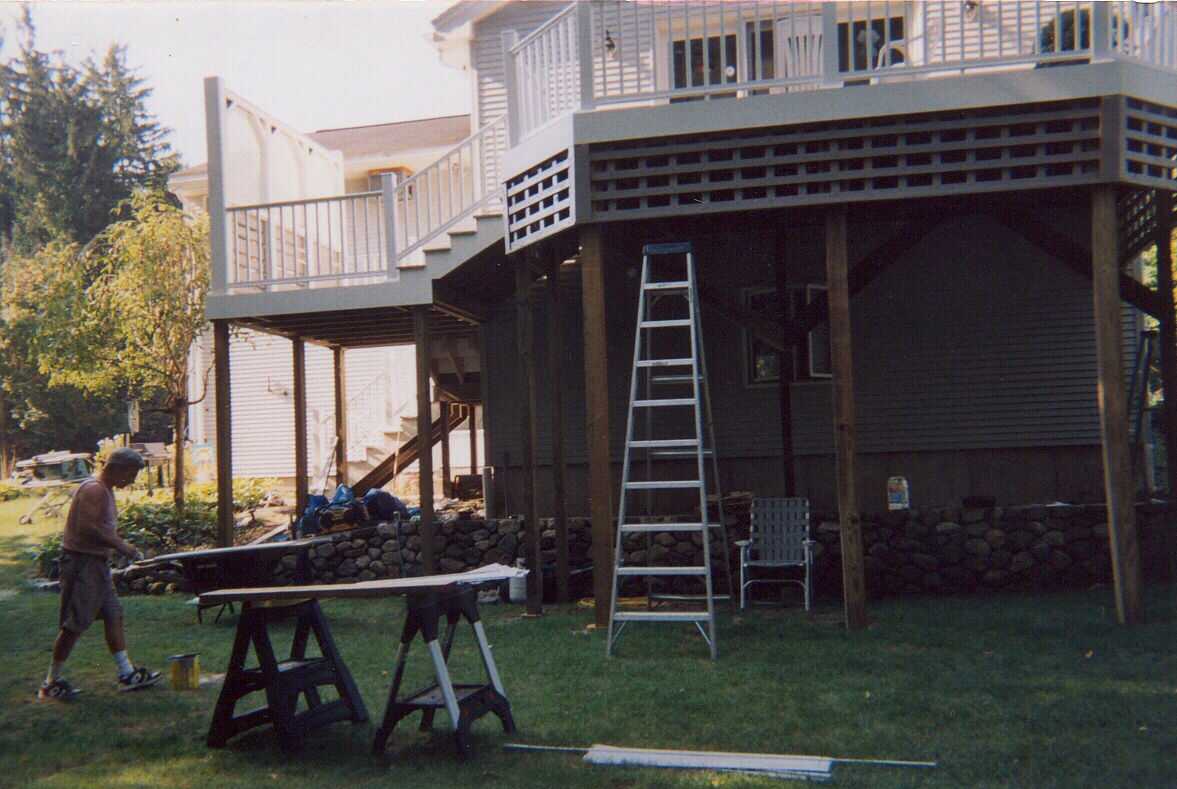 Tall composite deck with privacy screen and stairs.  Also front entry door.